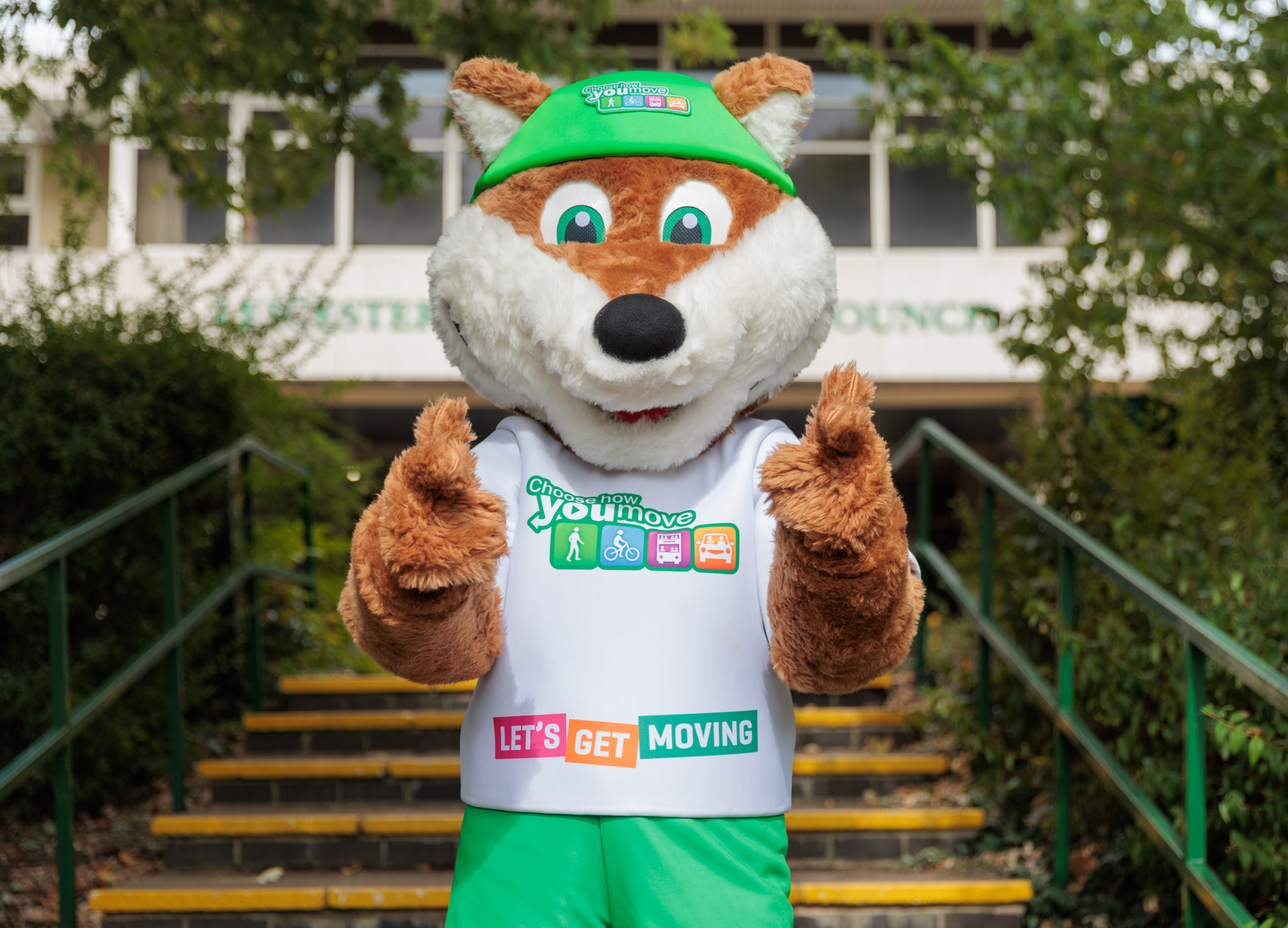 Picture of Theo Fox with his thumbs up outside of County Hall, to promote the Choose How You Move team.