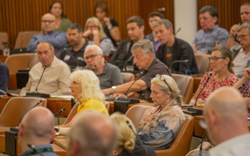 A group of people sit and listen at an event for cycling, walking and wheeling